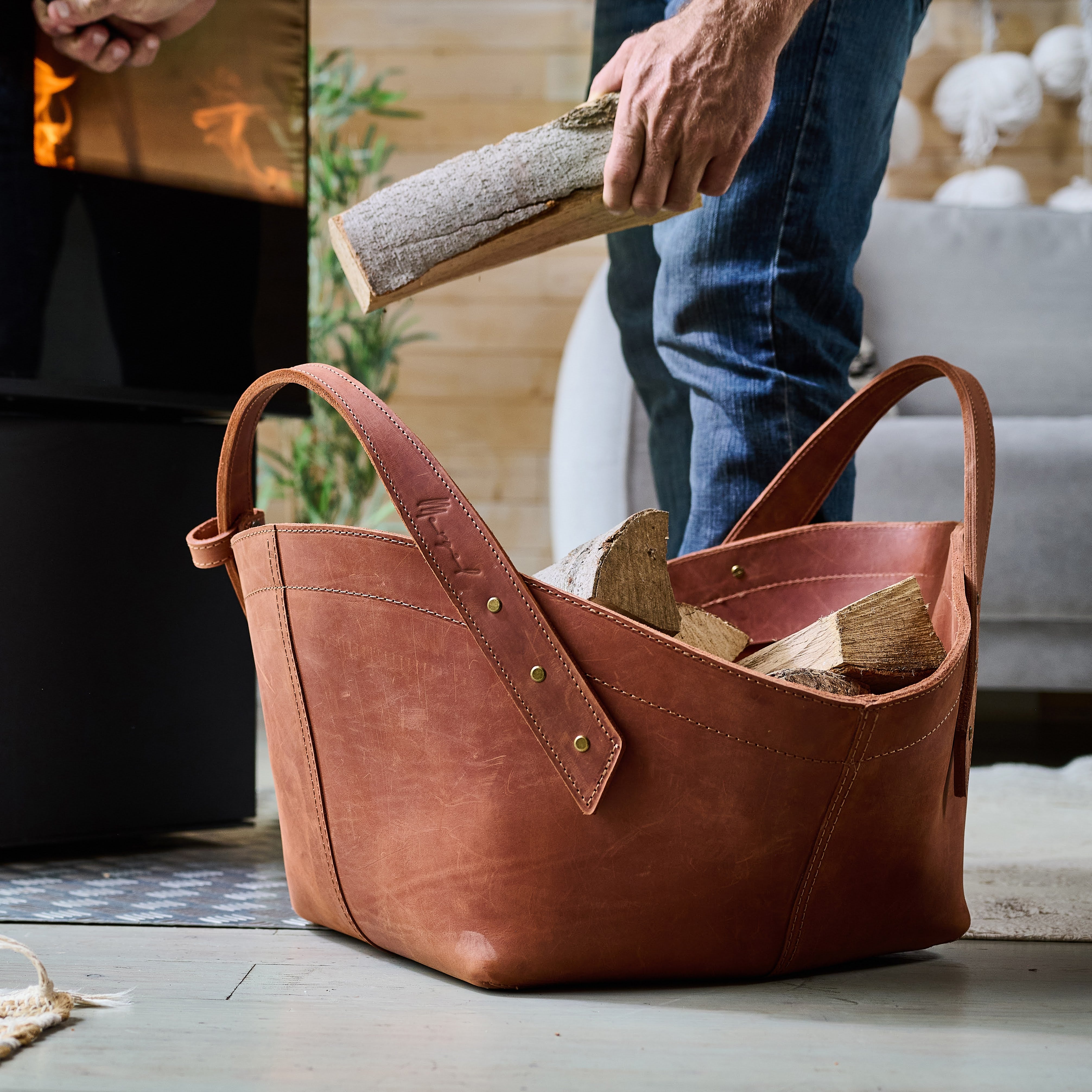 Leather firewood basket in cognac