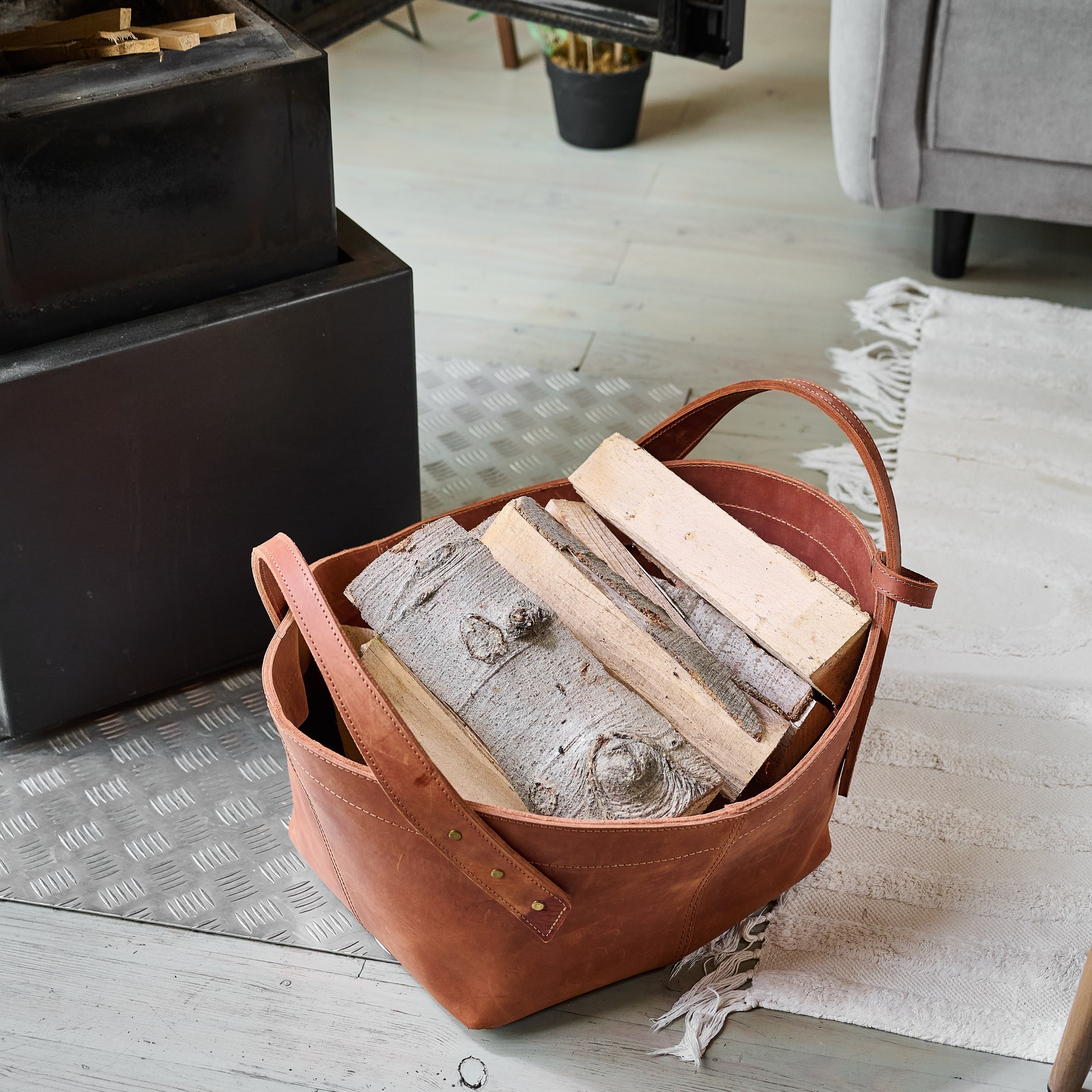 Leather firewood basket in cognac