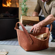 Leather firewood basket in cognac